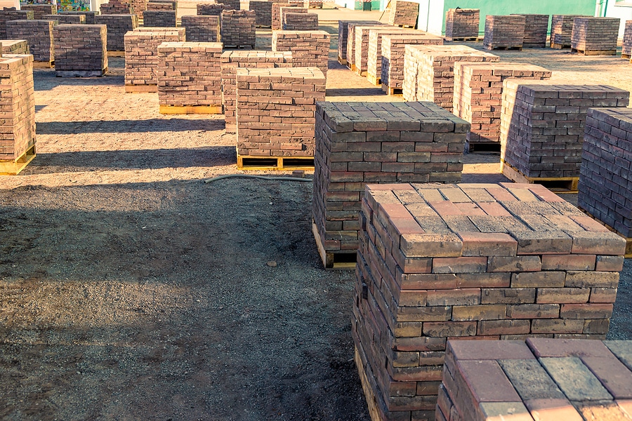 dismantled paving slabs or paving stones are stacked on pallets in the middle of the site waiting for removal, selective focus